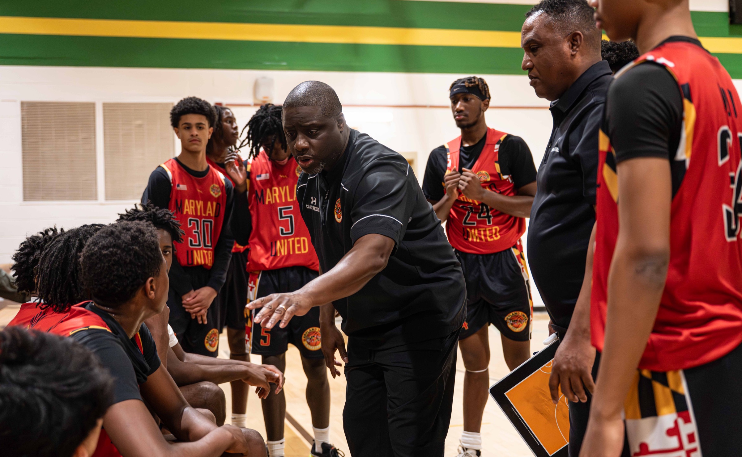 Maryland United coaches talking with the team in the gym
